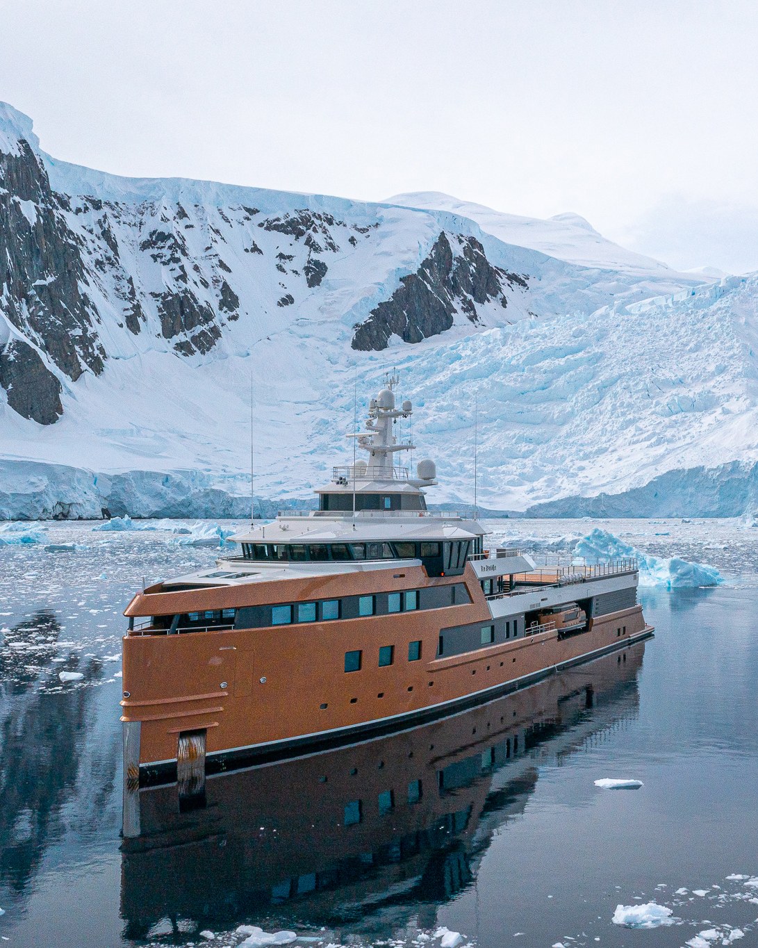 Born to Explore. La Datcha at anchor among Antarctic glaciers.