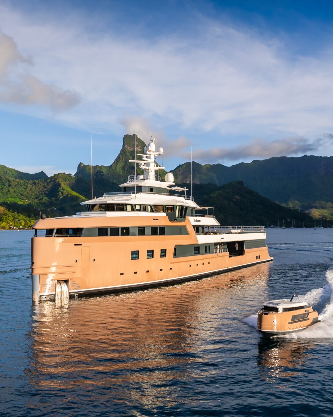 From the Ice to the Atolls. La Datcha at anchor off Moorea, French Polynesia, with her tender under way.