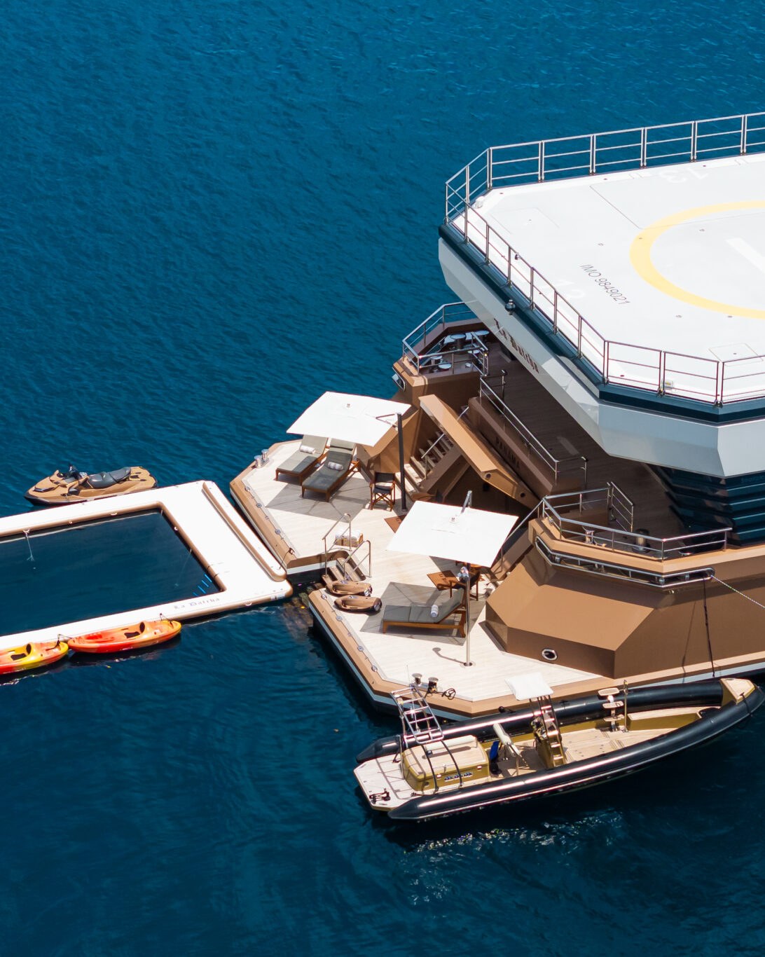 The Expedition Fleet. La Datcha's stern swim platform and tender in clear tropical water.